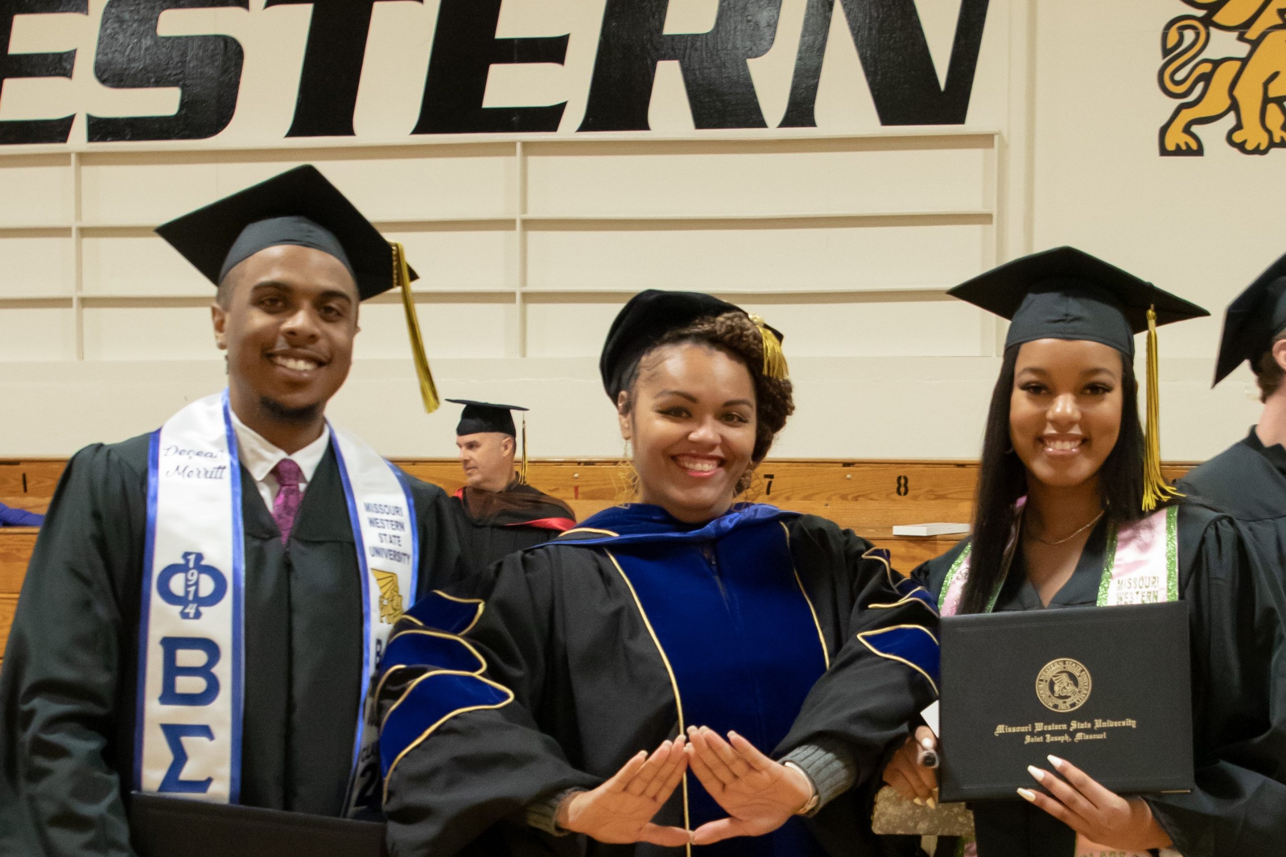 three graduates at alumni reception