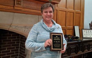 Dr. Kaye Adkins with her award