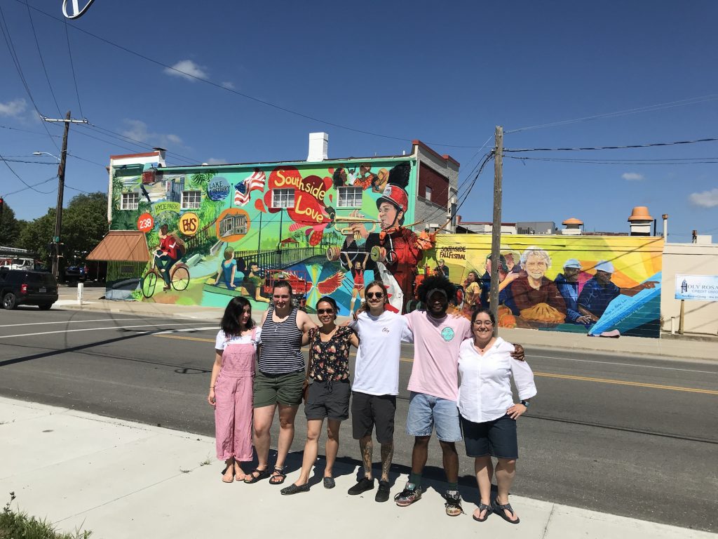 students in front of mural