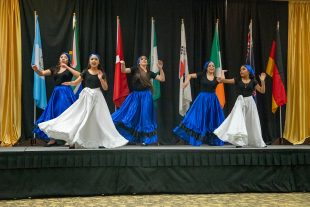 latin american dancers with international flags