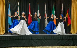 latin american dancers with international flags