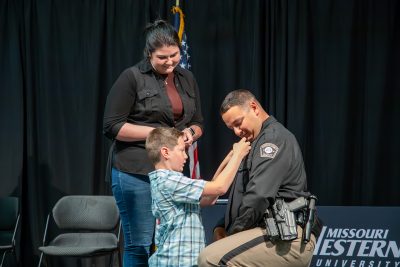 lea cadet receives badge from son