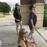 Marisa Steimel, Libby Steimel and Priscilla Steimel(sitting) watching the eclipse from the Clock Tower